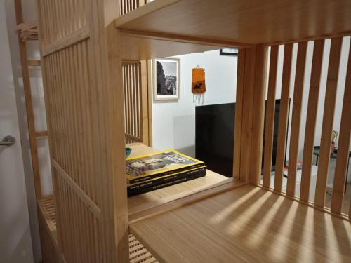 a room with a wooden door and a television at CASA da Corredoura by NaturAlegre in Portalegre
