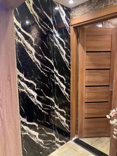 a bathroom with a black and white marble wall at Rahma Hotel Shehap in Cairo