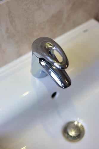 a bathroom sink with a chrome faucet at Clifton House Brighton in Portslade