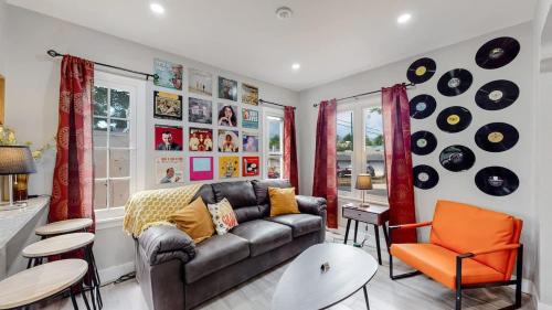 a living room with a couch and some records on the wall at groovy apartment in the heart of the city in Denver