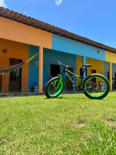 a bike parked in the grass in front of a building at The Jungle, Village & Beach in Guriú