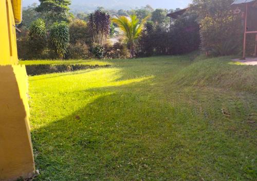 a field of grass with a shadow on it at Casa Hudié Campestre in Cachipay