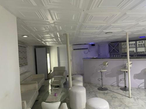 a room with a barber shop with chairs in it at Ibiyemi apartment in Abuja