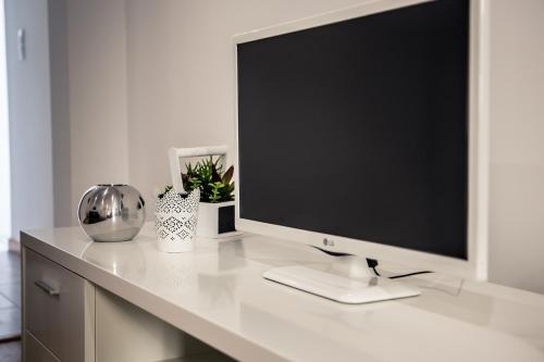 a computer monitor sitting on top of a desk at Casa Mãe Deus - House Azores in Ponta Delgada