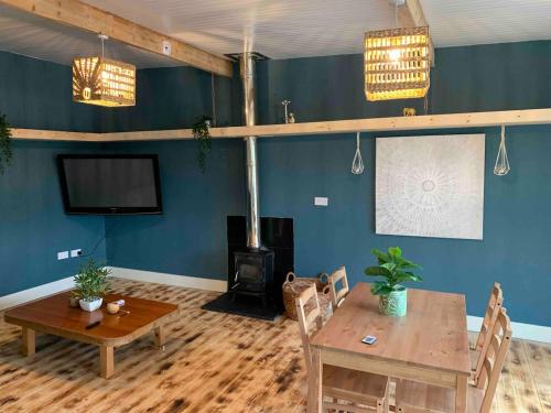 a living room with a table and a fireplace at The Cosy Castaway in Wexford