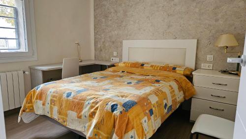 a bedroom with a bed and a dresser in it at la casita in Almazán