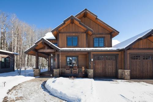 a wooden house with a gambrel roof at Lodge at Whitefish Lake in Whitefish