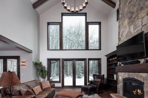 a living room with a couch and a fireplace at Lodge at Whitefish Lake in Whitefish