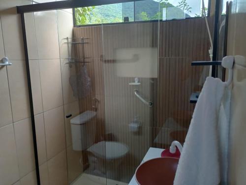 een badkamer met een glazen douche met toilet bij Chalé Duplex monte fuji ubatumirim in Ubatuba