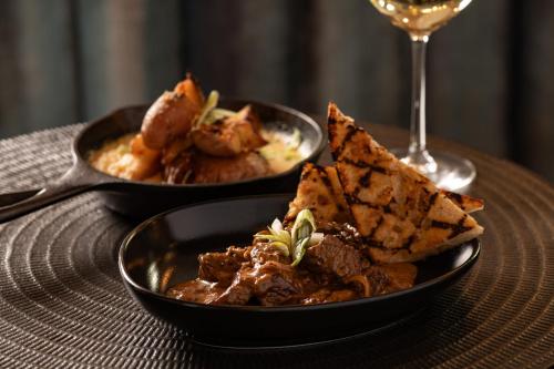 two bowls of food and a glass of wine at Allred Hotel in Newport