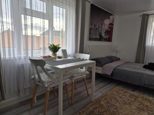 a room with a table and chairs and a bed at Garden Self Contained Studio in London in London