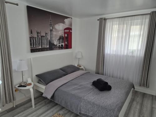 a bedroom with a bed and a large window at Garden Self Contained Studio in London in London