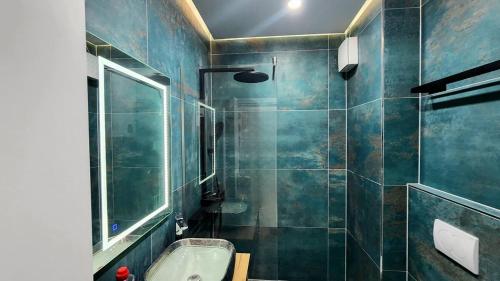 a bathroom with a sink and a bath tub at Alcatraz Apartment Durres in Durrës