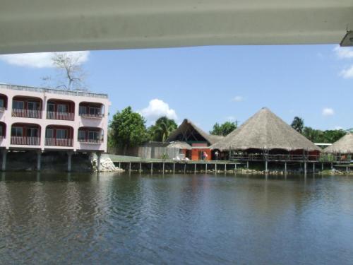 a view of a resort from the water at Lamanai Hotel & Marina in Orange Walk