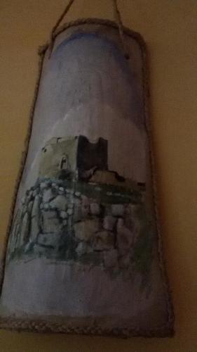 a painting of a castle hanging on a wall at B&B Troisi in Racalmuto