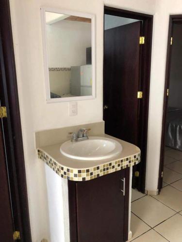 a bathroom with a sink and a mirror at Recidencial Pacifico in Rincon de Guayabitos