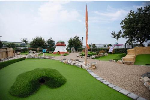 a garden with a fake number thirty in the grass at The Dragonfly Presthaven Sands in Prestatyn