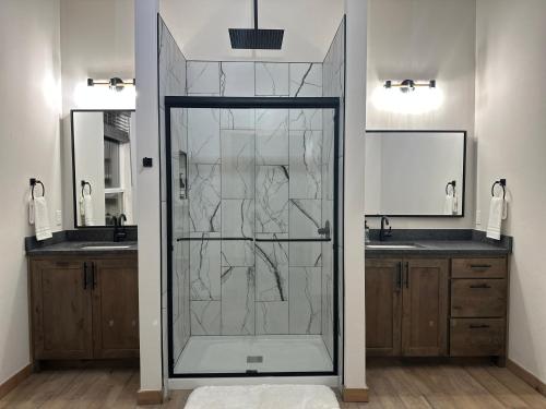 a glass shower in a bathroom with two sinks at New Bison Cabin Hot Tub Air Hockey Pool Table in Purcell
