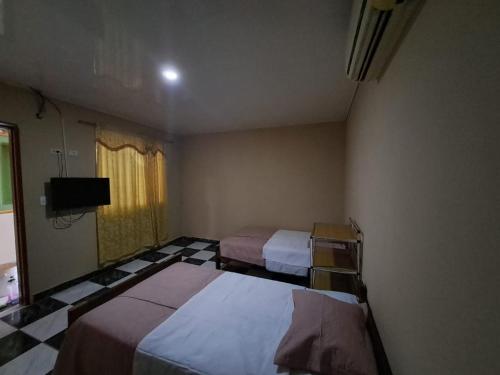 Кровать или кровати в номере Gran Hostal Amazonas Los Maderos