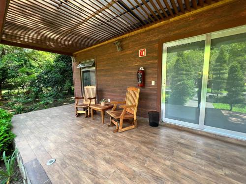 a patio with two chairs and a table on it at Yemaya Club in Santa María del Oro
