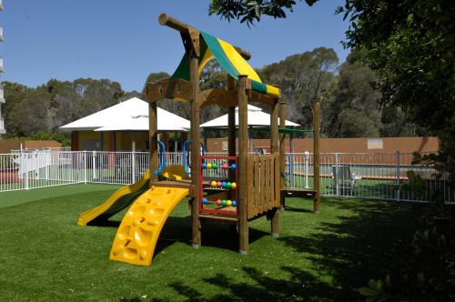 a playground with a slide in a park at Fairways Golf & Beach Retreat Bribie Island in Woorim
