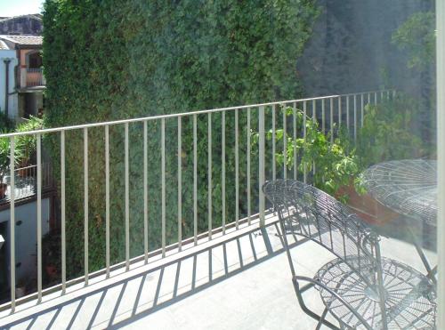 a metal bench on a balcony with a fence at Shalai - Exclusive SPA and small gourmet hotel in Linguaglossa