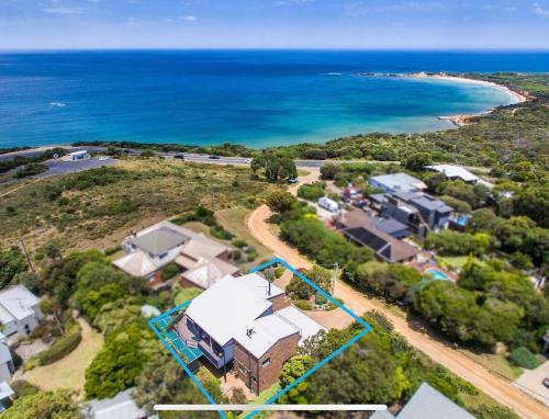 an aerial view of a house and the ocean at The Lookout Retreat in Anglesea