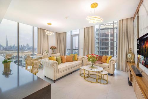 a living room with a couch and a tv at Luxury 2 Bedroom plus kids room Burj Khalifa View in Dubai