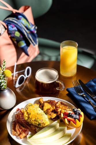 a plate of breakfast food on a table with a glass of orange juice at Crowne Plaza Virginia Beach Town Center by IHG in Virginia Beach