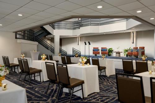 a banquet room with white tables and chairs at Crowne Plaza Virginia Beach Town Center by IHG in Virginia Beach