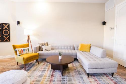 a living room with a couch and a table at Lakeside Luxury Val Vista in Gilbert