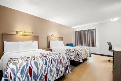 a hotel room with two beds and a window at Red Roof Inn Myrtle Beach Hotel - Market Commons in Myrtle Beach