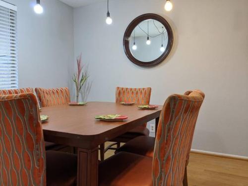 a dining room table with chairs and a mirror at Gorgeous Escape with a Pool in Fabulous Las Vegas in Las Vegas