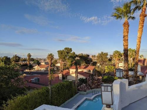 a view of a resort with a swimming pool and palm trees at Gorgeous Escape with a Pool in Fabulous Las Vegas in Las Vegas