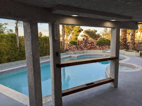 a view of a swimming pool through two windows at Gorgeous Escape with a Pool in Fabulous Las Vegas in Las Vegas