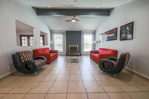 a living room with red couches and a fireplace at Gorgeous Escape with a Pool in Fabulous Las Vegas in Las Vegas