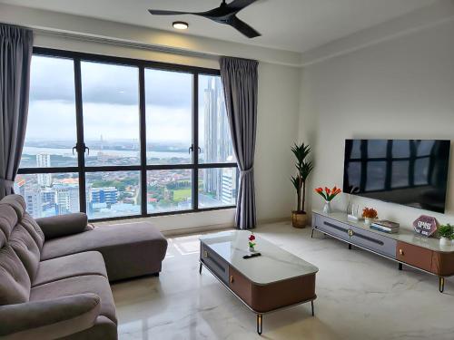a living room with a couch and a large window at Sky88 Seaview 4BR Indoor Pool-Mahjong-Netflix in Johor Bahru