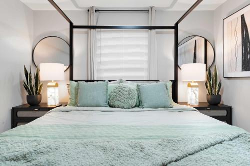 a bedroom with a large bed with two lamps at Spacious Family Getaway LCP Collection in Hanover Park