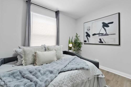 a bedroom with a bed with a large window at Spacious Family Getaway LCP Collection in Hanover Park