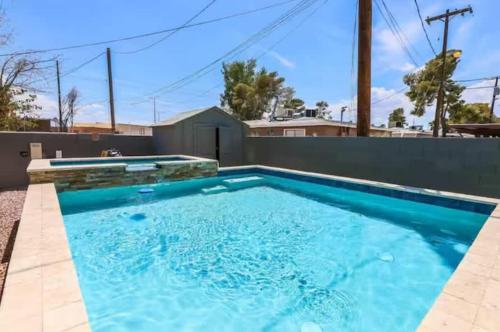 a swimming pool with blue water in a house at Modern Elegance in the Heart of Las Vegas in Las Vegas
