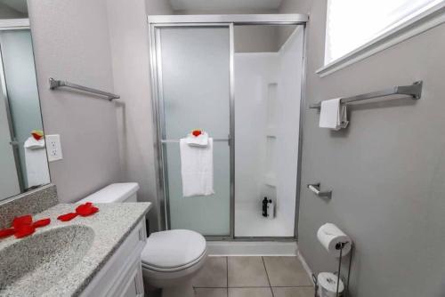 a bathroom with a shower with a toilet and a sink at Modern Elegance in the Heart of Las Vegas in Las Vegas