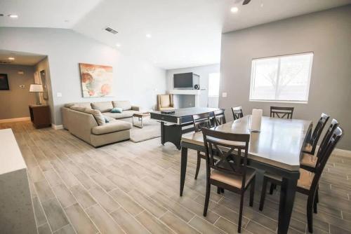 a living room with a table and chairs and a couch at Spacious Stylish and Convenient in Las Vegas