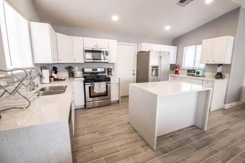 a kitchen with white cabinets and a white counter top at Spacious Stylish and Convenient in Las Vegas