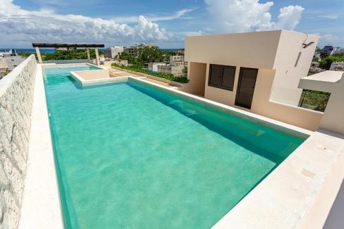 a swimming pool in the middle of a house with water at Beautiful Loft near the Beach in Playa del Carmen