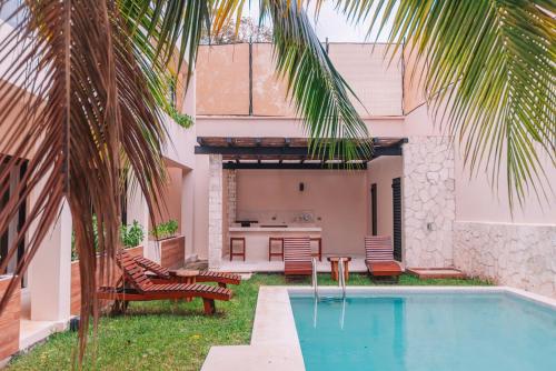 a backyard with a swimming pool and a house at Beautiful Loft near the Beach in Playa del Carmen