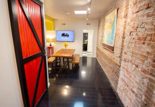 a hallway with a red door and a brick wall at Unique denver loft in rino art district in Denver