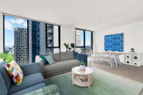 a living room with a couch and a table at Nook Melbourne Apartments Zen in Melbourne