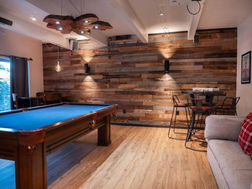 a pool table in a living room with a wooden wall at Updated Cabin near Beach&Ski HotTub Sauna Pets EV in Tahoe City