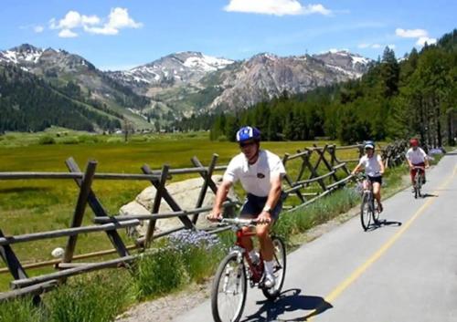 a group of people riding bikes down a road at Updated Cabin near Beach&Ski HotTub Sauna Pets EV in Tahoe City
