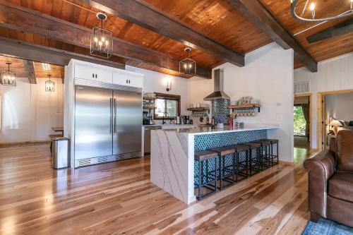 an open kitchen with a stainless steel refrigerator at Updated Cabin near Beach&Ski HotTub Sauna Pets EV in Tahoe City